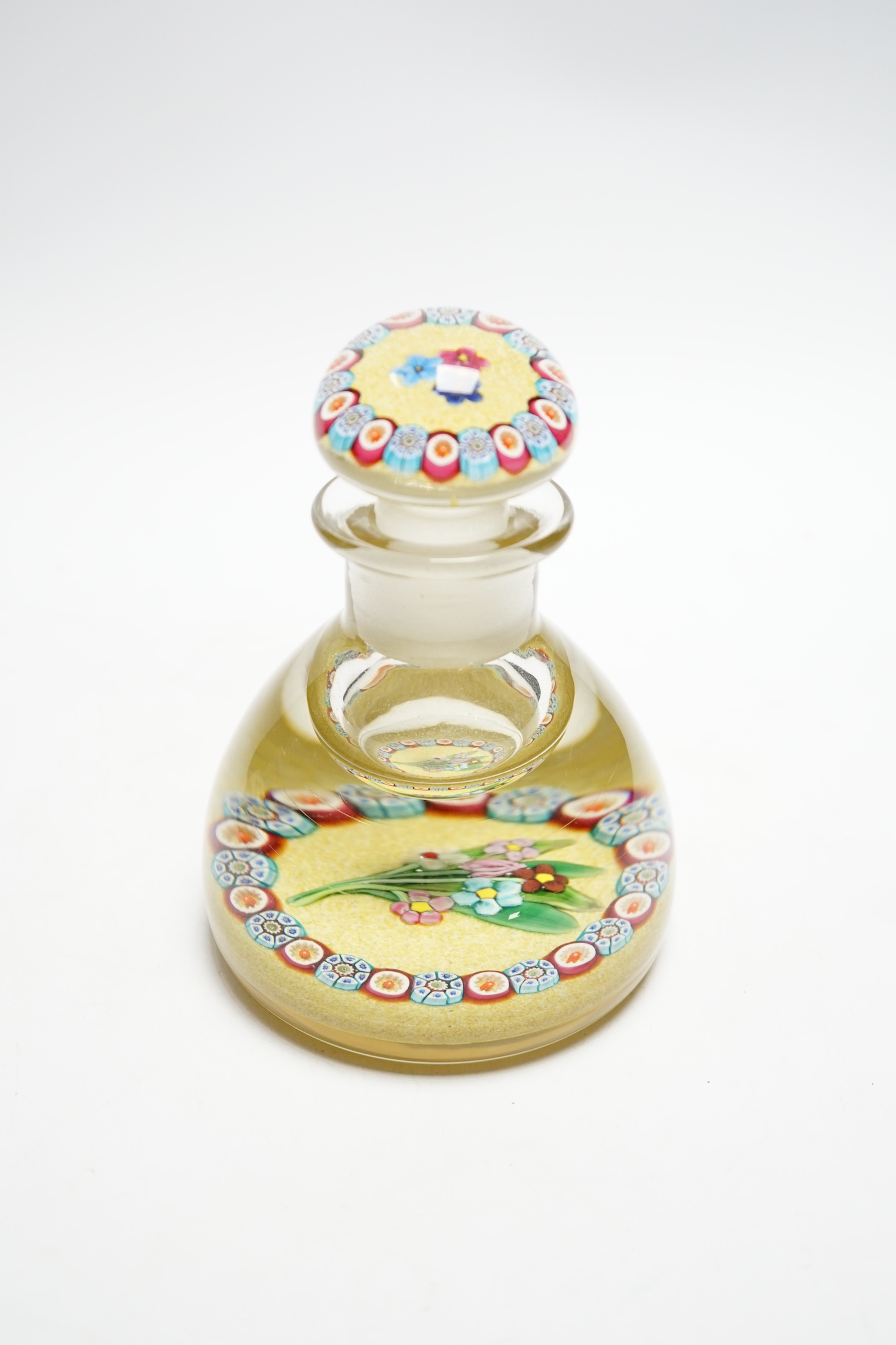 A rare Paul Ysart ‘small flower bouquet’ glass inkwell or bottle and stopper, Caithness period, scratched signature ‘P. Ysart’, sand coloured jasper ground, 10cm diameter, 14cm high